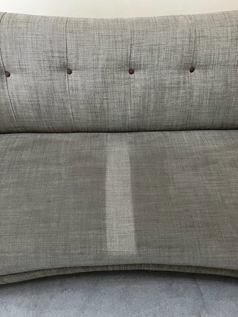 Comparison between cleaned section of a sofa and dirty a section of a sofa.